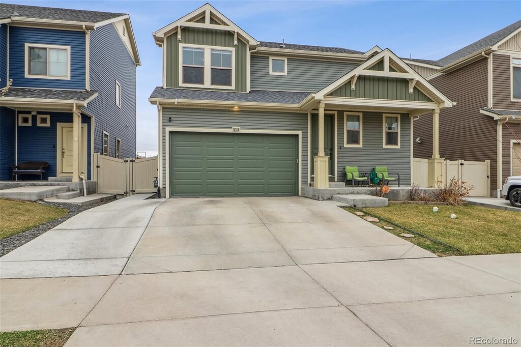 18108 E 52nd Ave, Denver, CO 80249 - view of front of home featuring a gate, fence, board and batten siding, and a porch
