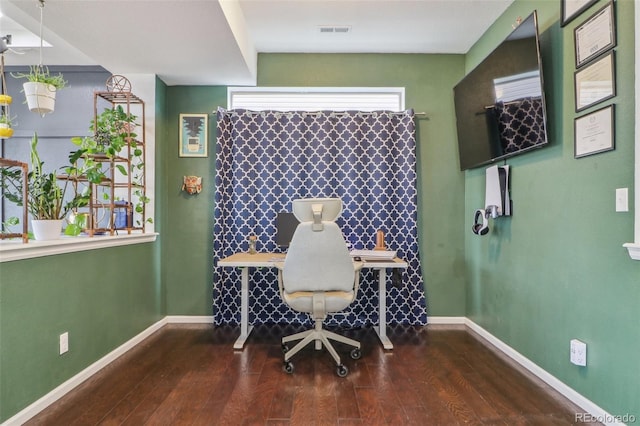 office area featuring baseboards, visible vents, and wood finished floors