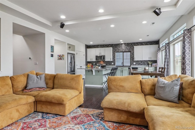 living room featuring visible vents, recessed lighting, and dark wood-style flooring