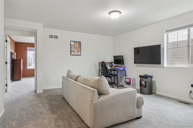 living area featuring carpet floors, baseboards, and visible vents