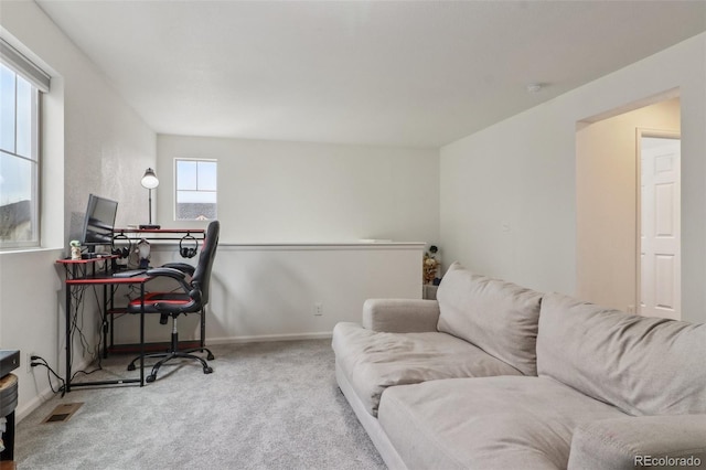 carpeted office with baseboards and visible vents