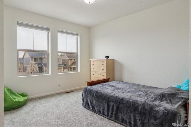 bedroom featuring baseboards, visible vents, and carpet floors