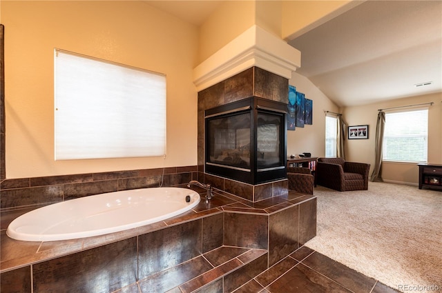 3902 Eagle Tail Ln, Castle Rock, CO 80104 - bathroom with a garden tub, vaulted ceiling, and tile patterned flooring