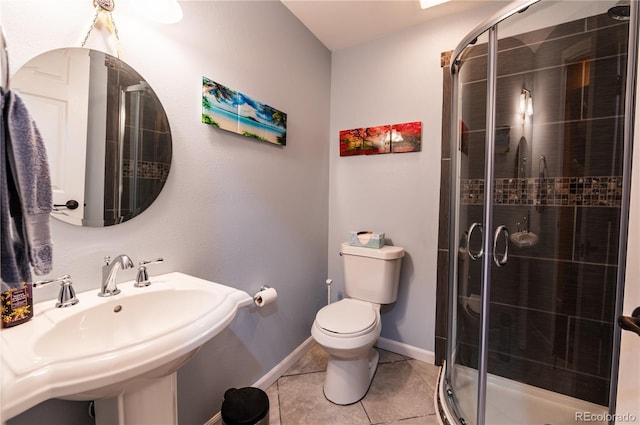 3902 Eagle Tail Ln, Castle Rock, CO 80104 - bathroom featuring a shower stall, tile patterned floors, toilet, a sink, and baseboards