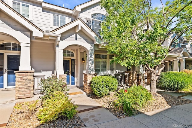 8399 Stonybridge Cir, Highlands Ranch, CO 80126 - view of exterior entry with stone siding and covered porch