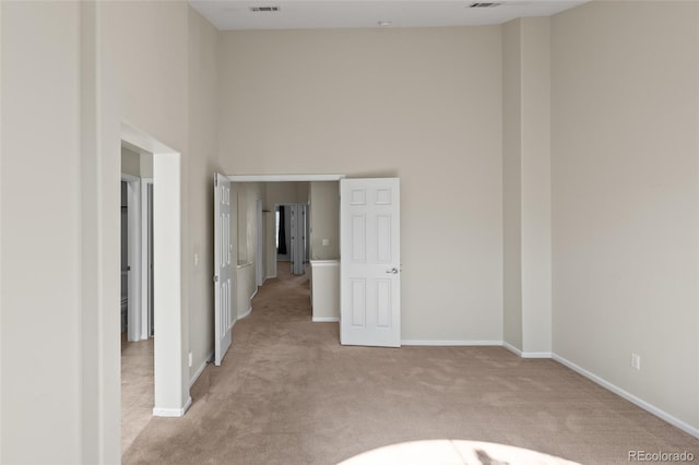 8399 Stonybridge Cir, Highlands Ranch, CO 80126 - empty room featuring a towering ceiling and light colored carpet