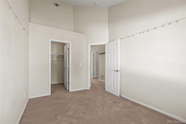 8399 Stonybridge Cir, Highlands Ranch, CO 80126 - unfurnished bedroom with carpet, a spacious closet, a closet, and a towering ceiling