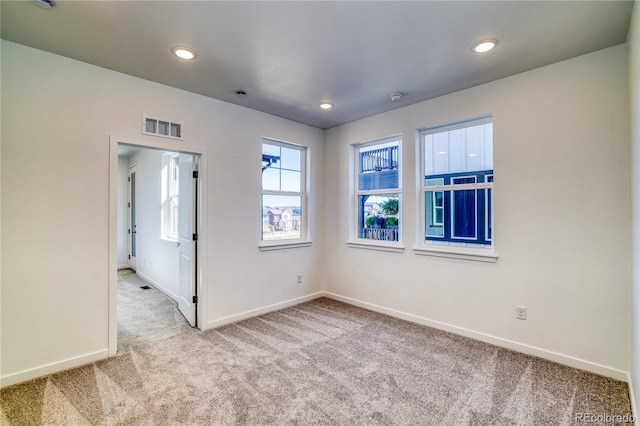 carpeted spare room with visible vents, recessed lighting, and baseboards