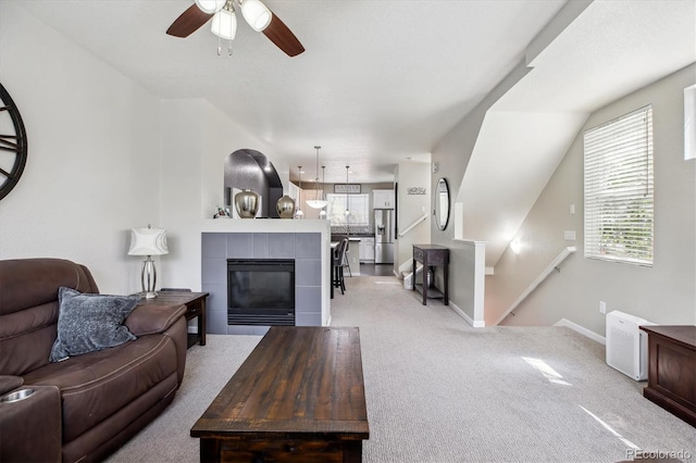 9300 E Florida Ave Unit 1107, Denver, CO 80247 - living area featuring light carpet, a tile fireplace, baseboards, and ceiling fan