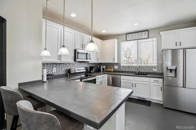 9300 E Florida Ave Unit 1107, Denver, CO 80247 - kitchen with backsplash, a peninsula, stainless steel appliances, and a sink