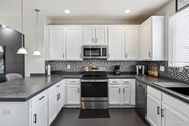 9300 E Florida Ave Unit 1107, Denver, CO 80247 - kitchen featuring stainless steel appliances, backsplash, dark countertops, a sink, and a peninsula