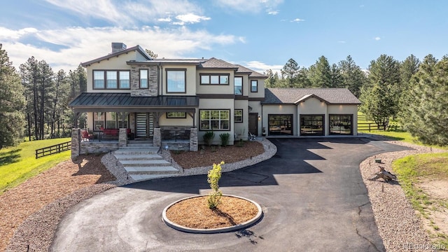 230 S Big Meadow Trl, Franktown, CO 80116 - view of front facade featuring a porch, stucco siding, stone siding, and curved driveway