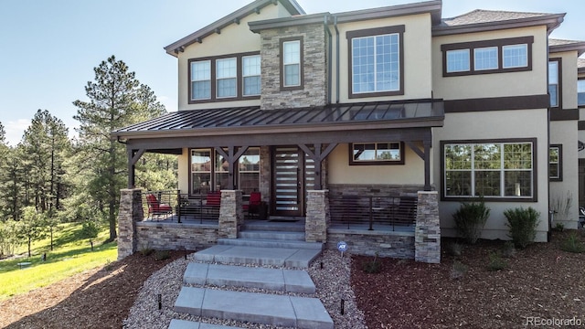 230 S Big Meadow Trl, Franktown, CO 80116 - view of front of property with a porch, stucco siding, a standing seam roof, and stone siding