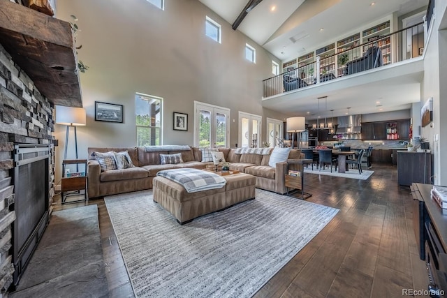 230 S Big Meadow Trl, Franktown, CO 80116 - living area featuring a towering ceiling, a fireplace, and dark wood-style floors