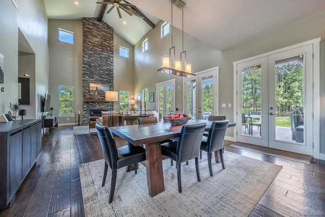 230 S Big Meadow Trl, Franktown, CO 80116 - dining room with french doors, healthy amount of natural light, a stone fireplace, high vaulted ceiling, and dark wood-style flooring