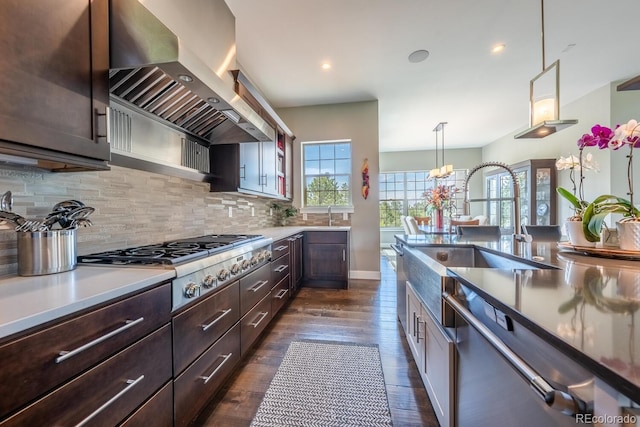 230 S Big Meadow Trl, Franktown, CO 80116 - kitchen featuring wall chimney exhaust hood, stainless steel appliances, dark brown cabinets, tasteful backsplash, and recessed lighting