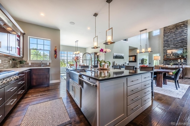 230 S Big Meadow Trl, Franktown, CO 80116 - kitchen with a sink, stainless steel appliances, dark countertops, dark wood finished floors, and decorative backsplash