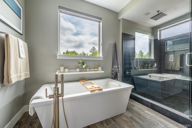 230 S Big Meadow Trl, Franktown, CO 80116 - bathroom with wood finished floors, a freestanding bath, a shower stall, and baseboards