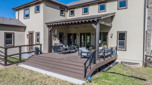 230 S Big Meadow Trl, Franktown, CO 80116 - rear view of house with a wooden deck, stucco siding, and outdoor dining area