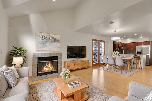 living room with light hardwood / wood-style flooring and lofted ceiling