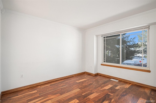 spare room featuring wood-type flooring and crown molding