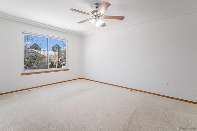 unfurnished room with carpet floors, ceiling fan, and crown molding