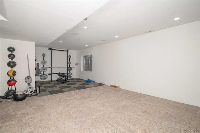 exercise area featuring dark carpet