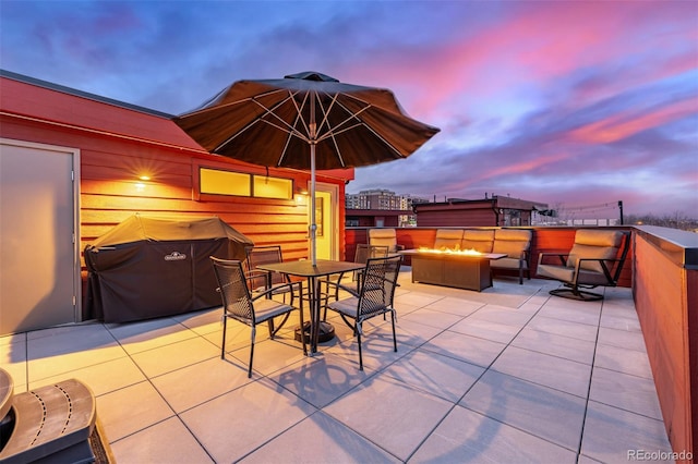 2350 Tremont Pl Unit 13, Denver, CO 80205 - patio terrace at dusk with a patio area, outdoor dining area, an outdoor living space with a fire pit, and a grill