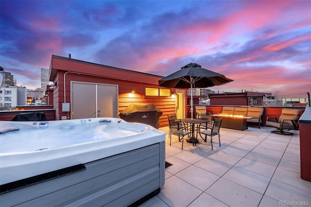 2350 Tremont Pl Unit 13, Denver, CO 80205 - view of patio / terrace featuring a hot tub, a fire pit, a view of city, and outdoor dining space