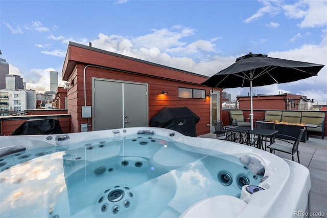 2350 Tremont Pl Unit 13, Denver, CO 80205 - view of patio / terrace featuring a hot tub, a grill, and a fire pit