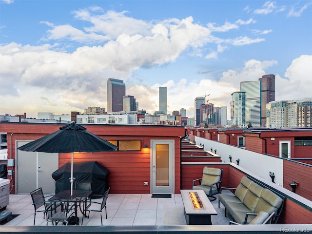 2350 Tremont Pl Unit 13, Denver, CO 80205 - view of patio featuring a view of skyline, an outdoor living space with a fire pit, and grilling area