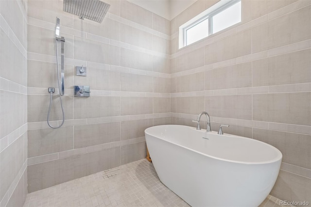 2350 Tremont Pl Unit 13, Denver, CO 80205 - bathroom featuring a freestanding bath, tiled shower, tile patterned floors, and tile walls