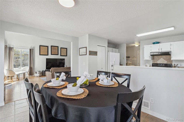 5425 W 115th Pl, Westminster, CO 80020 - dining space featuring light tile patterned flooring, a textured ceiling, and baseboards