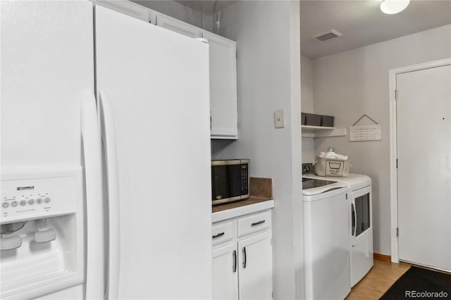 5425 W 115th Pl, Westminster, CO 80020 - laundry area with independent washer and dryer and light tile patterned floors