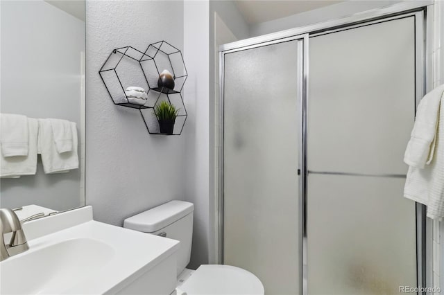 5425 W 115th Pl, Westminster, CO 80020 - bathroom with a shower stall, toilet, a textured wall, and vanity