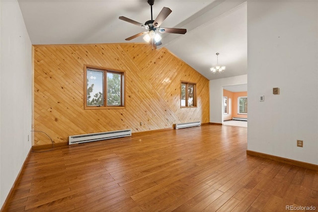 723 Brussels Dr, Parker, CO 80138 - unfurnished living room featuring baseboard heating, wooden walls, a chandelier, a ceiling fan, and wood-type flooring