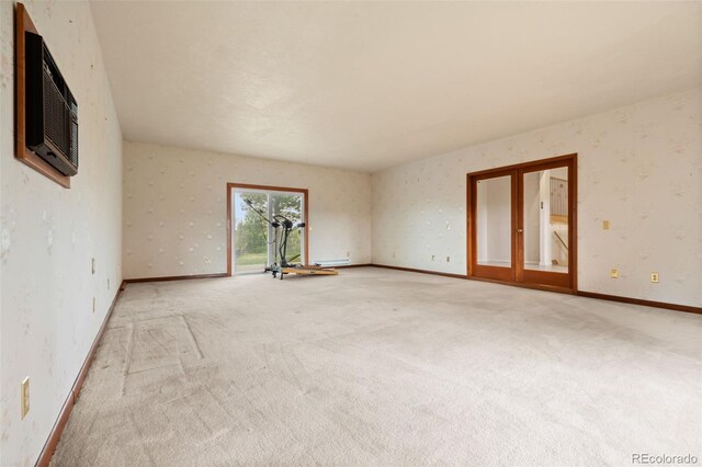723 Brussels Dr, Parker, CO 80138 - spare room featuring light carpet, wallpapered walls, and a wall mounted AC