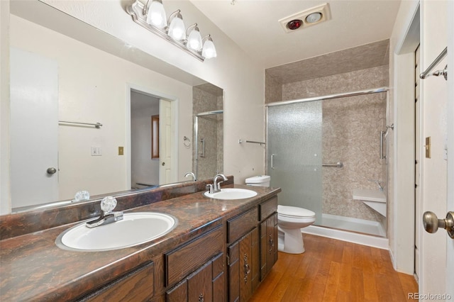 723 Brussels Dr, Parker, CO 80138 - bathroom with wood finished floors, double vanity, and a shower stall