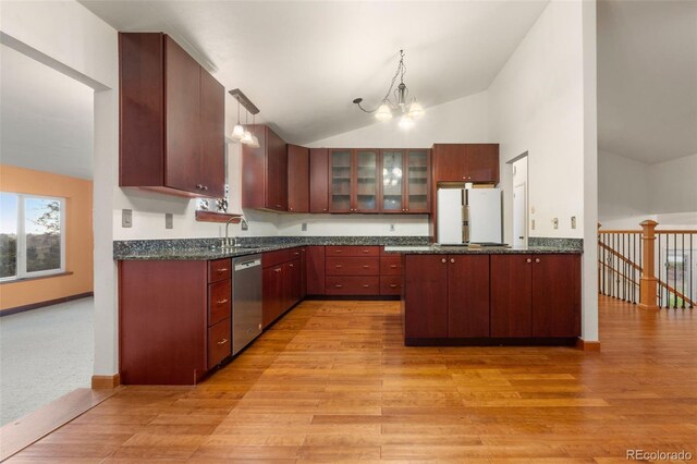 723 Brussels Dr, Parker, CO 80138 - kitchen featuring freestanding refrigerator, dishwasher, vaulted ceiling, a peninsula, and light wood-style flooring