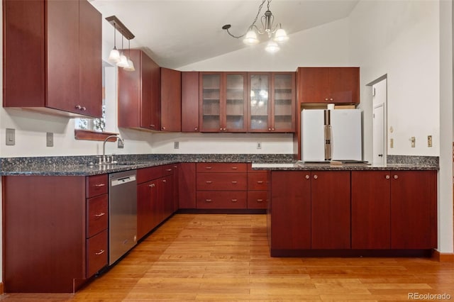 723 Brussels Dr, Parker, CO 80138 - kitchen with freestanding refrigerator, stainless steel dishwasher, vaulted ceiling, light wood-type flooring, and a peninsula