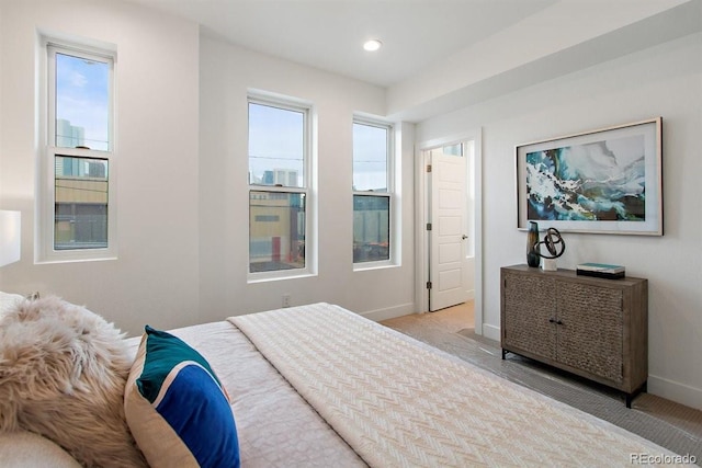 bedroom featuring multiple windows and light carpet