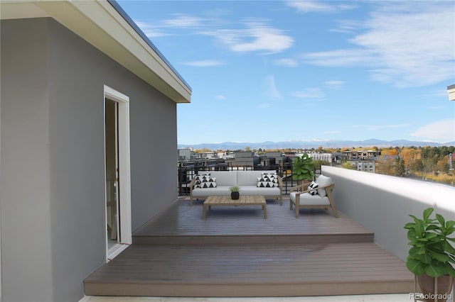 deck featuring a mountain view and an outdoor living space