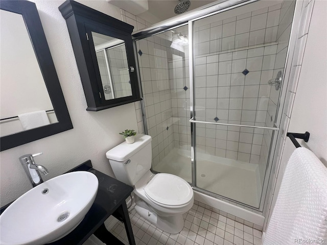 137 Bob Cat Trl, Bailey, CO 80421 - full bathroom featuring a stall shower, a sink, toilet, and tile patterned floors