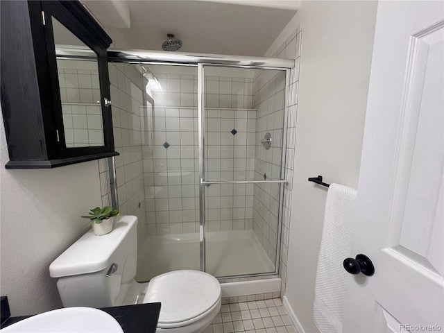 137 Bob Cat Trl, Bailey, CO 80421 - full bathroom featuring a shower stall, toilet, tile patterned flooring, and baseboards