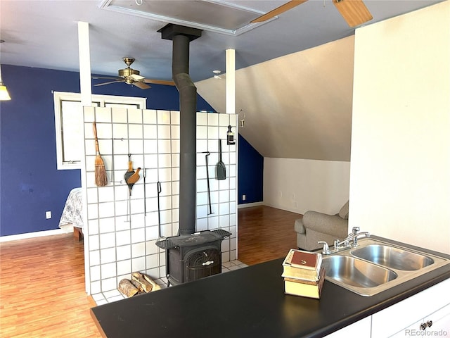 137 Bob Cat Trl, Bailey, CO 80421 - kitchen with a wood stove, a sink, wood finished floors, baseboards, and a ceiling fan