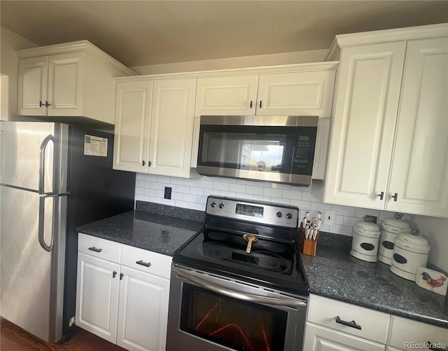 137 Bob Cat Trl, Bailey, CO 80421 - kitchen with appliances with stainless steel finishes, white cabinets, decorative backsplash, and dark stone counters