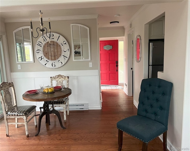 137 Bob Cat Trl, Bailey, CO 80421 - dining space featuring crown molding, wood finished floors, a wainscoted wall, and baseboards