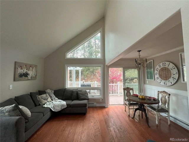 137 Bob Cat Trl, Bailey, CO 80421 - living room with a chandelier, wood finished floors, high vaulted ceiling, healthy amount of natural light, and a baseboard radiator