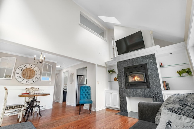 137 Bob Cat Trl, Bailey, CO 80421 - living room with a high end fireplace, built in shelves, wood finished floors, ornamental molding, and baseboards