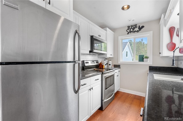 137 Bob Cat Trl, Bailey, CO 80421 - kitchen featuring appliances with stainless steel finishes, light wood-style floors, a sink, white cabinets, and recessed lighting
